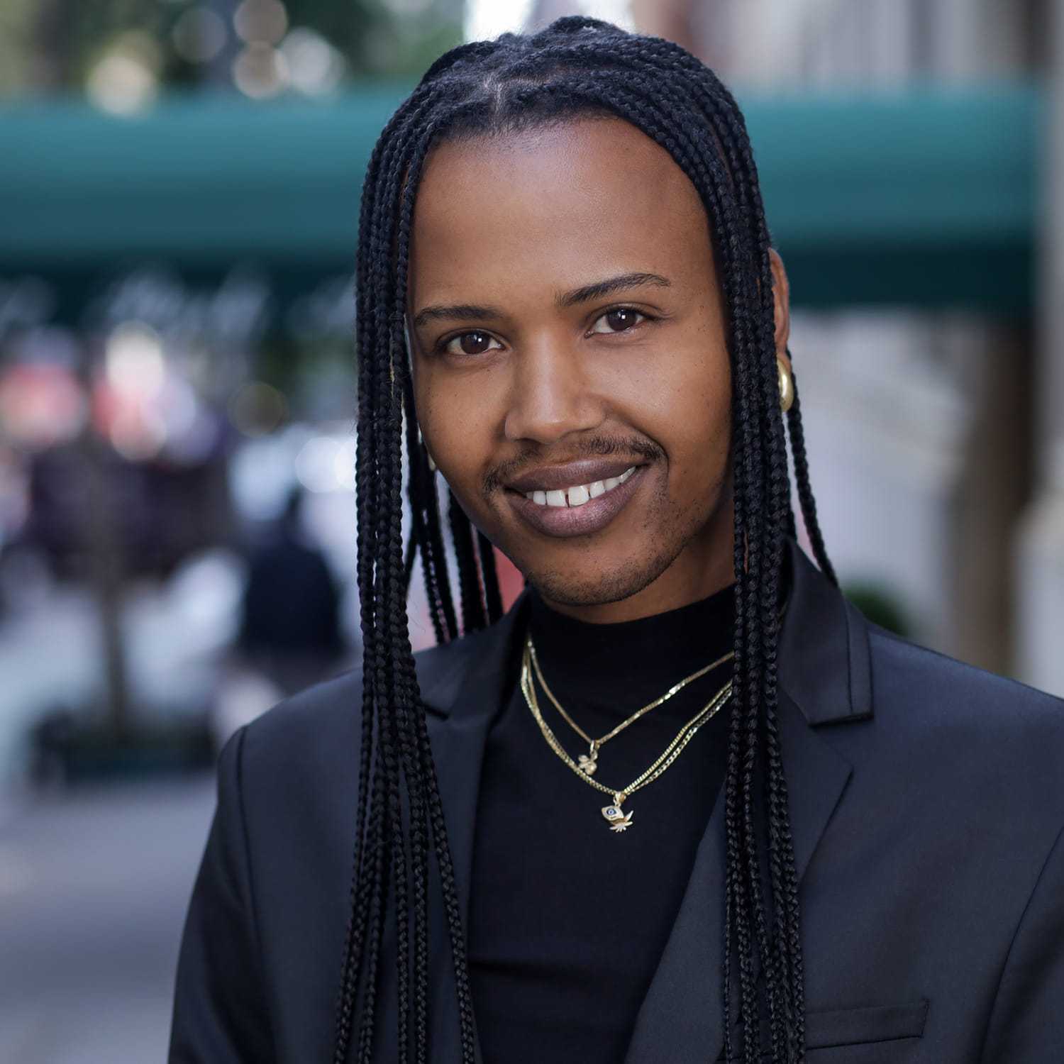 Portrait of RASHIK, a professional stylist at Fringe Salon NY, showcasing their expertise and style.