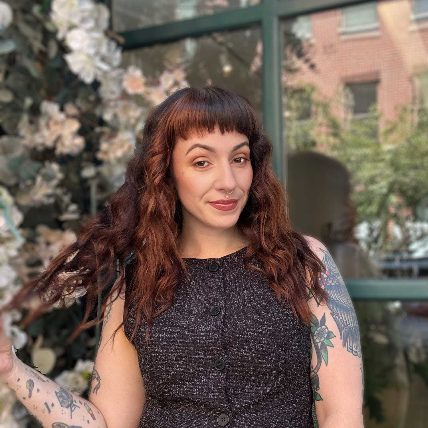 Portrait of KAMMI, a professional stylist at Fringe Salon NY, showcasing their expertise and style.